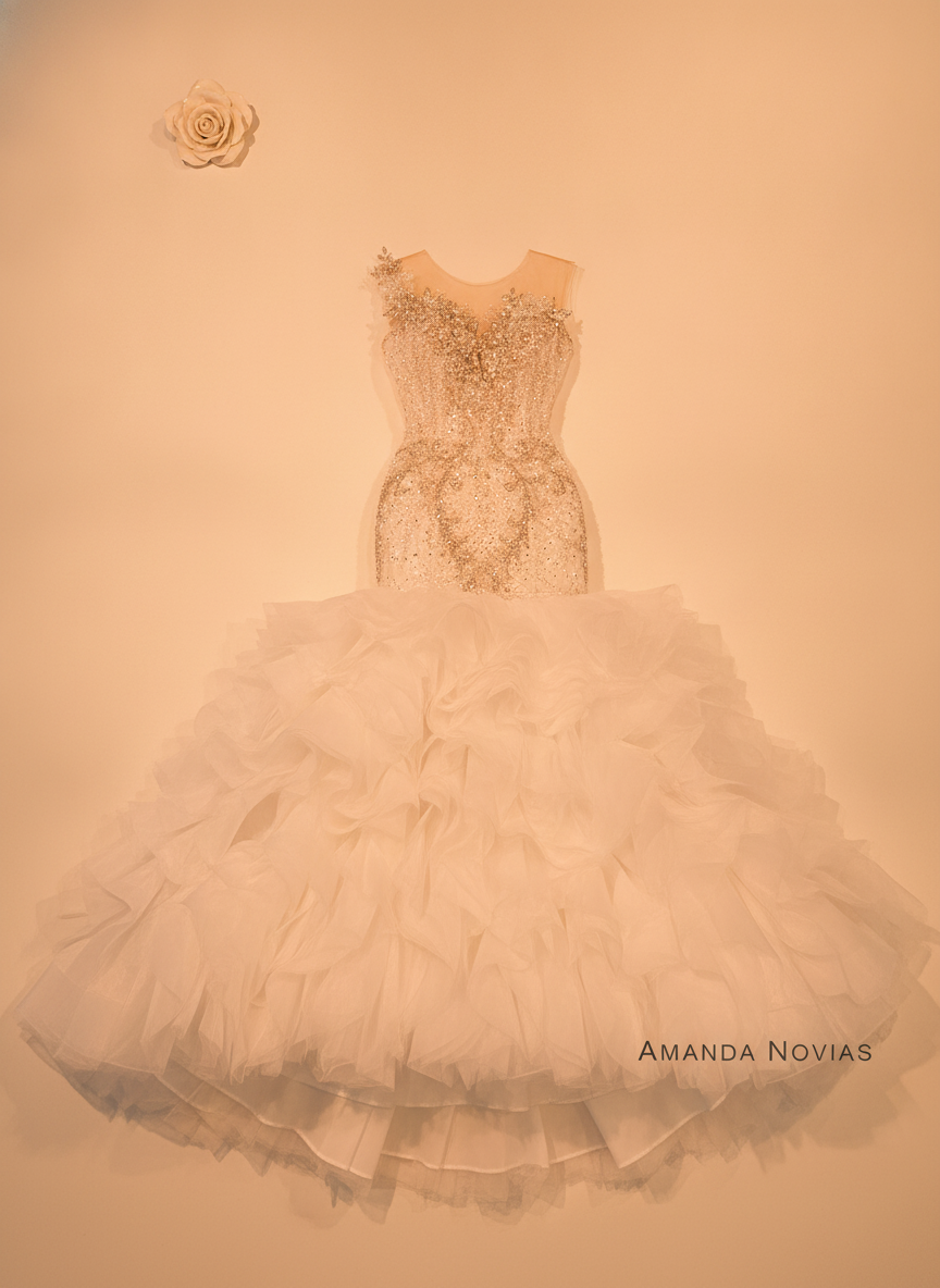 Close-up flat-lay of a white Custom Ruffle Mermaid Wedding Dress, highlighting the ruffled skirt and mermaid silhouette on a 